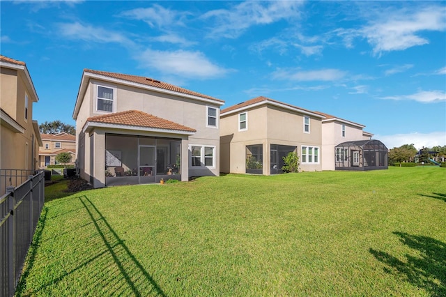 rear view of house featuring a lawn