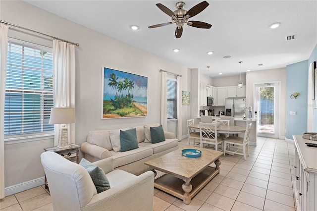 living room featuring light tile patterned floors and ceiling fan