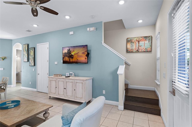 tiled living room with ceiling fan