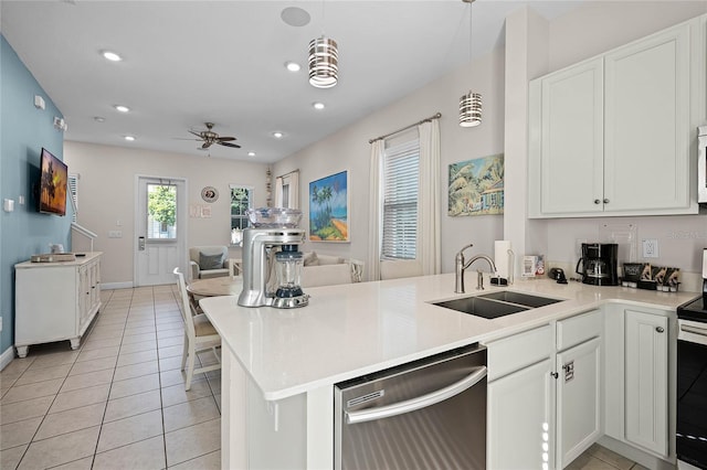 kitchen with sink, hanging light fixtures, stainless steel appliances, kitchen peninsula, and white cabinets