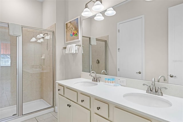 bathroom with tile patterned flooring, vanity, and an enclosed shower