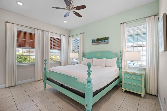 tiled bedroom with multiple windows and ceiling fan