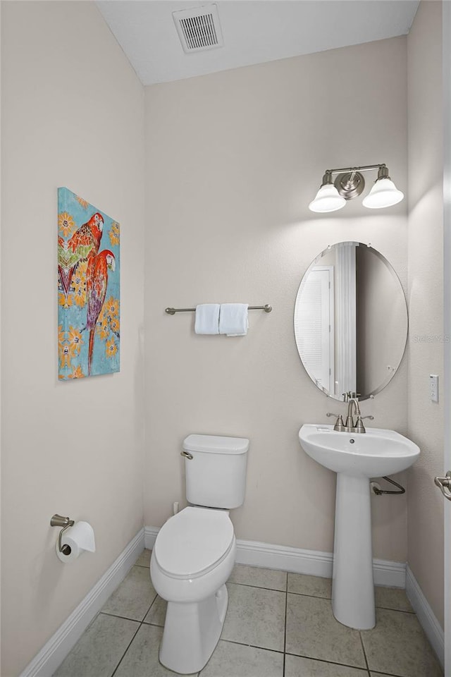 bathroom with tile patterned flooring and toilet