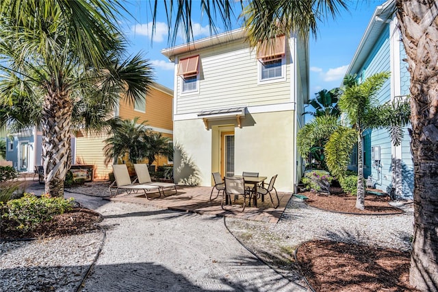 rear view of house featuring a patio