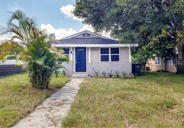 bungalow-style home featuring a front yard