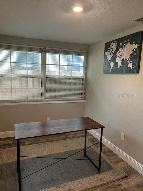 office area featuring hardwood / wood-style floors and a textured ceiling