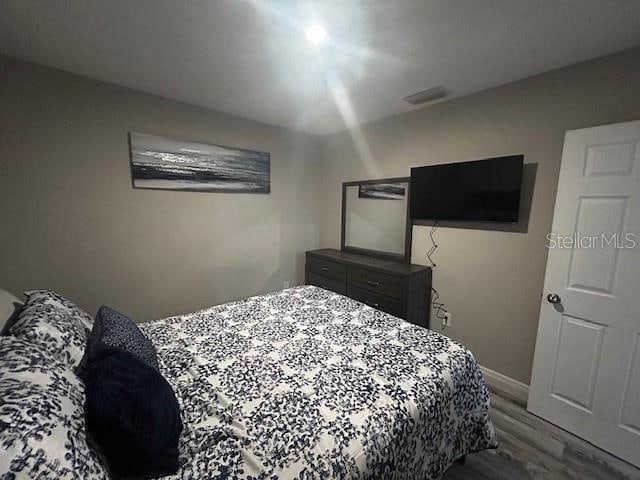 bedroom featuring wood-type flooring