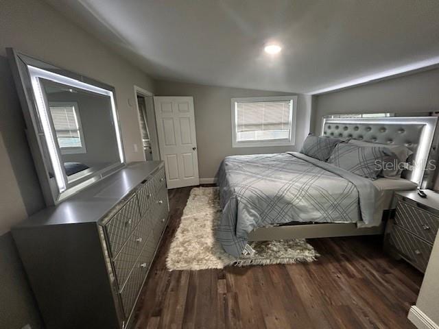 bedroom with dark hardwood / wood-style floors and vaulted ceiling