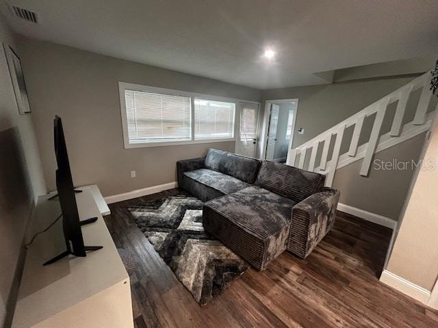 living room with dark hardwood / wood-style floors