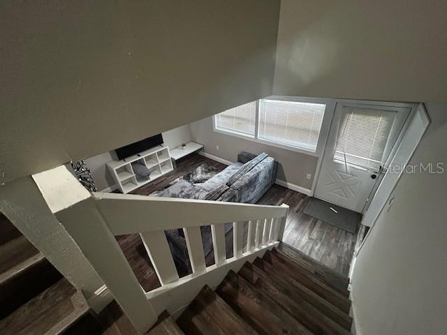 staircase with wood-type flooring