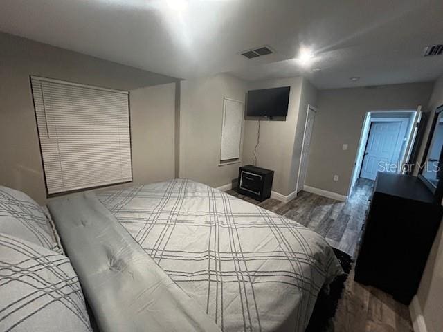 bedroom with hardwood / wood-style flooring