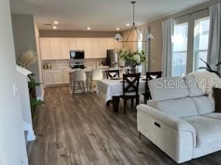 living room featuring crown molding and dark hardwood / wood-style floors