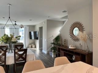 dining space with dark wood-type flooring