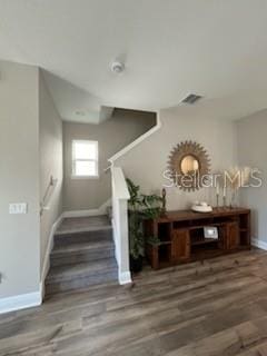 stairway with hardwood / wood-style flooring