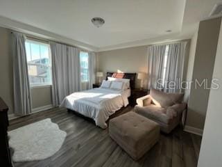 bedroom with dark wood-type flooring