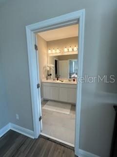 bathroom with hardwood / wood-style flooring