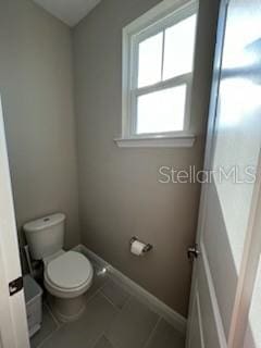 bathroom featuring tile patterned floors and toilet