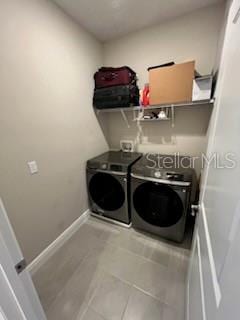 laundry room featuring tile patterned floors and independent washer and dryer