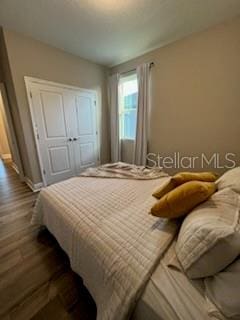 bedroom featuring dark wood-type flooring