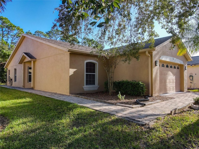 ranch-style house with a front yard and a garage