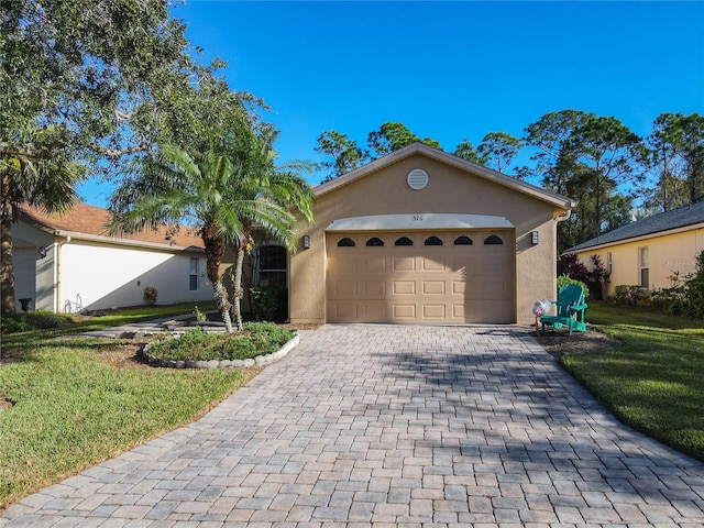 view of front of home featuring a garage and a front yard