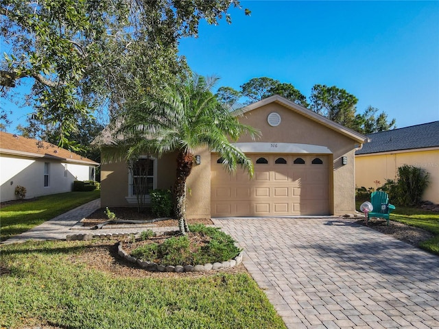 view of front of home featuring a front lawn and a garage