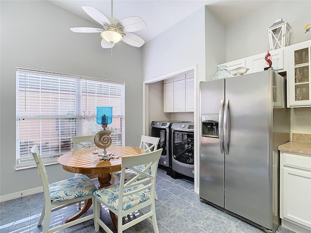 kitchen with washer and dryer, stainless steel fridge with ice dispenser, white cabinetry, and ceiling fan