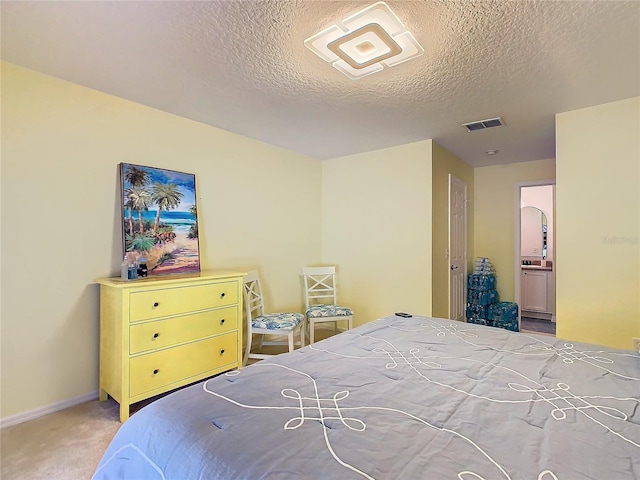 bedroom with light carpet and a textured ceiling