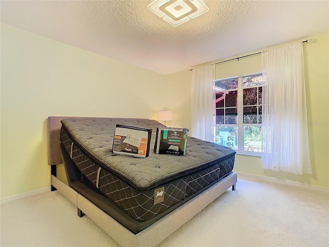 bedroom featuring carpet floors and a textured ceiling