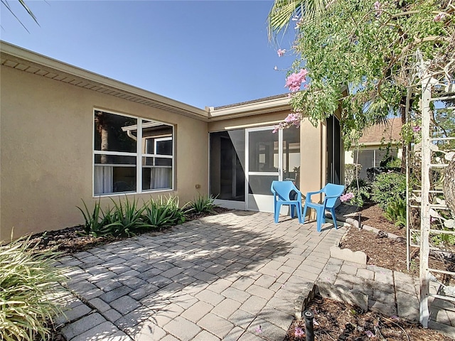 view of patio featuring a sunroom