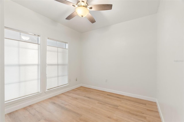 empty room with ceiling fan and light wood-type flooring