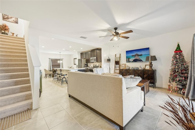 tiled living room featuring ceiling fan