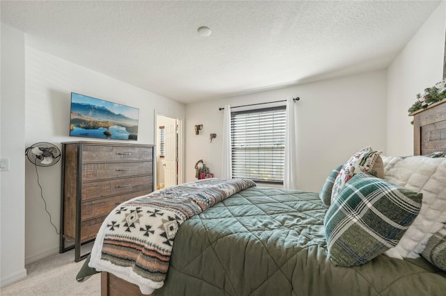 bedroom featuring a textured ceiling and light carpet