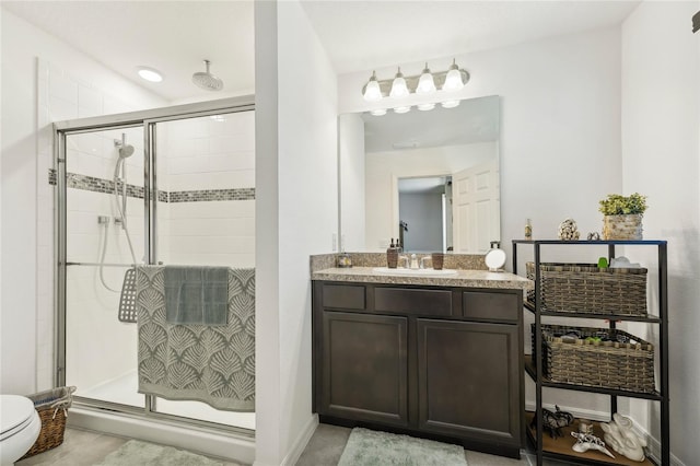 bathroom with vanity, toilet, and walk in shower