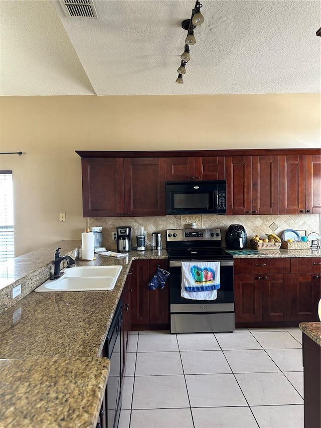 kitchen featuring tasteful backsplash, appliances with stainless steel finishes, sink, and stone counters