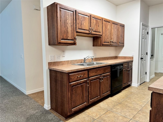 kitchen with dishwasher, light tile patterned floors, and sink