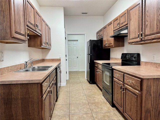 kitchen with sink, light tile patterned floors, and black appliances