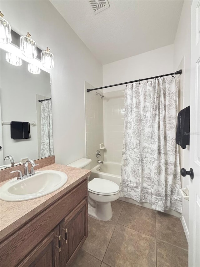 full bathroom with vanity, a textured ceiling, shower / bath combo with shower curtain, tile patterned flooring, and toilet