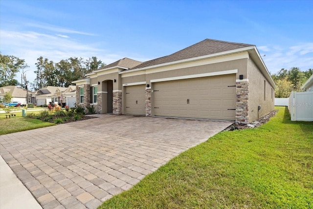 view of front of home featuring a front lawn and a garage