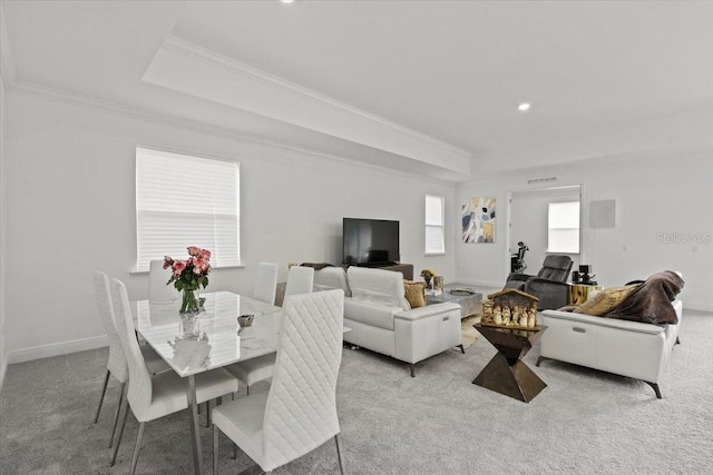 dining room featuring light carpet and ornamental molding