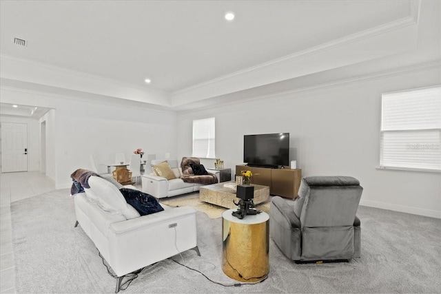 carpeted living room with a tray ceiling, a wealth of natural light, and ornamental molding