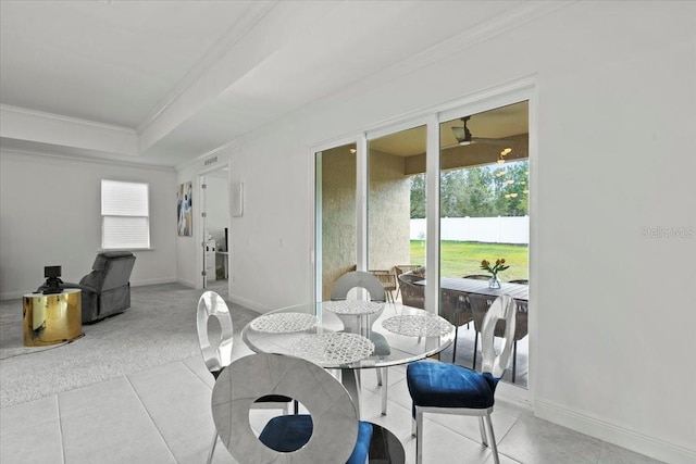 dining area featuring ceiling fan, crown molding, and light tile patterned flooring