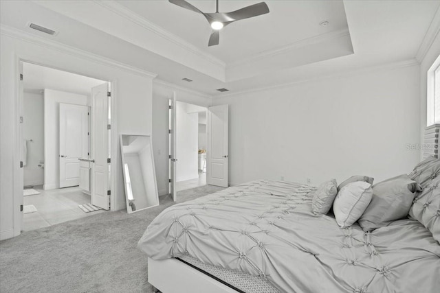 carpeted bedroom featuring a raised ceiling, ceiling fan, and crown molding