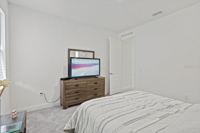 bedroom featuring light carpet