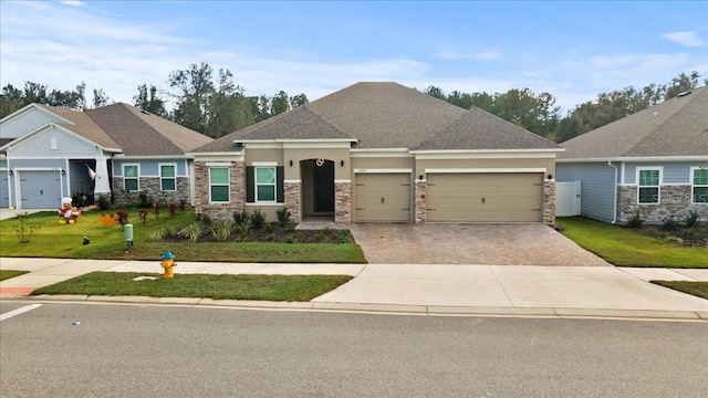 view of front of home featuring a front yard and a garage