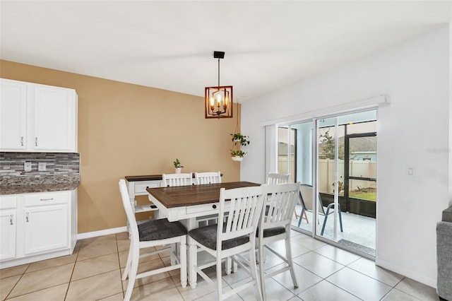 tiled dining area with a chandelier