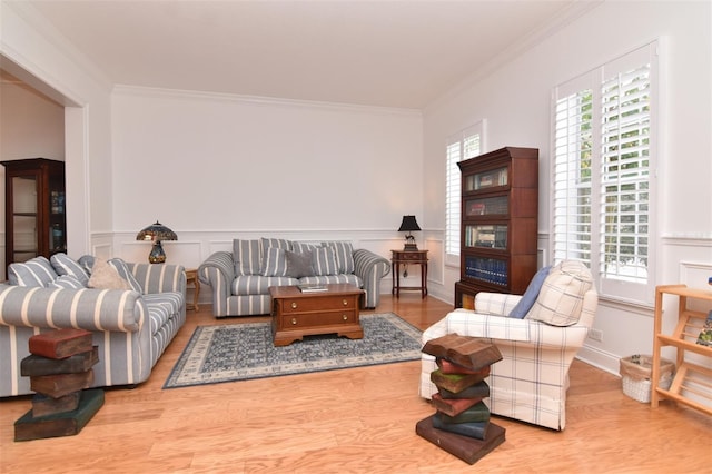 living room featuring light hardwood / wood-style flooring and ornamental molding