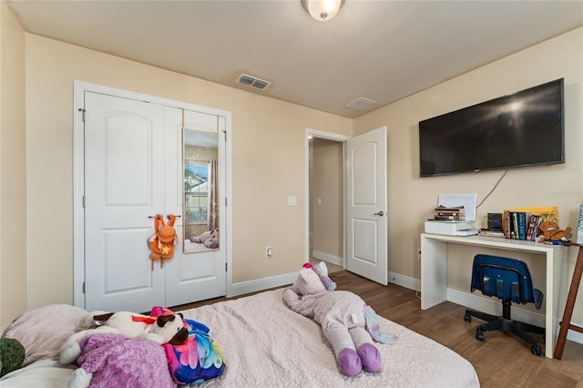 bedroom with hardwood / wood-style flooring and a closet