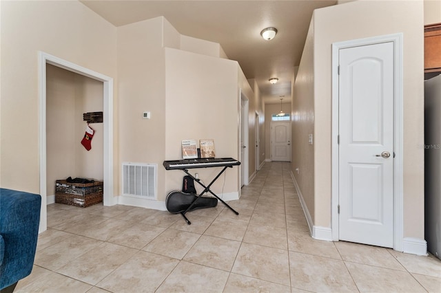 corridor featuring light tile patterned floors