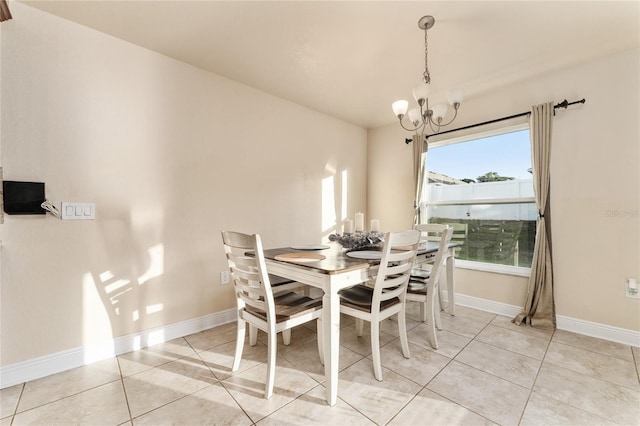 dining room with a notable chandelier and light tile patterned flooring